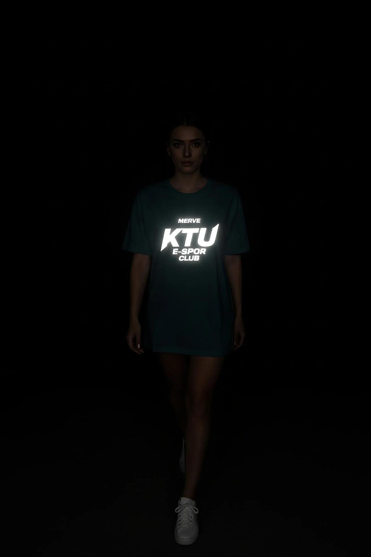 Custom E-Sports Club Shirt Close-Up White Logo on Black Fabric Glowing in Dark Front View