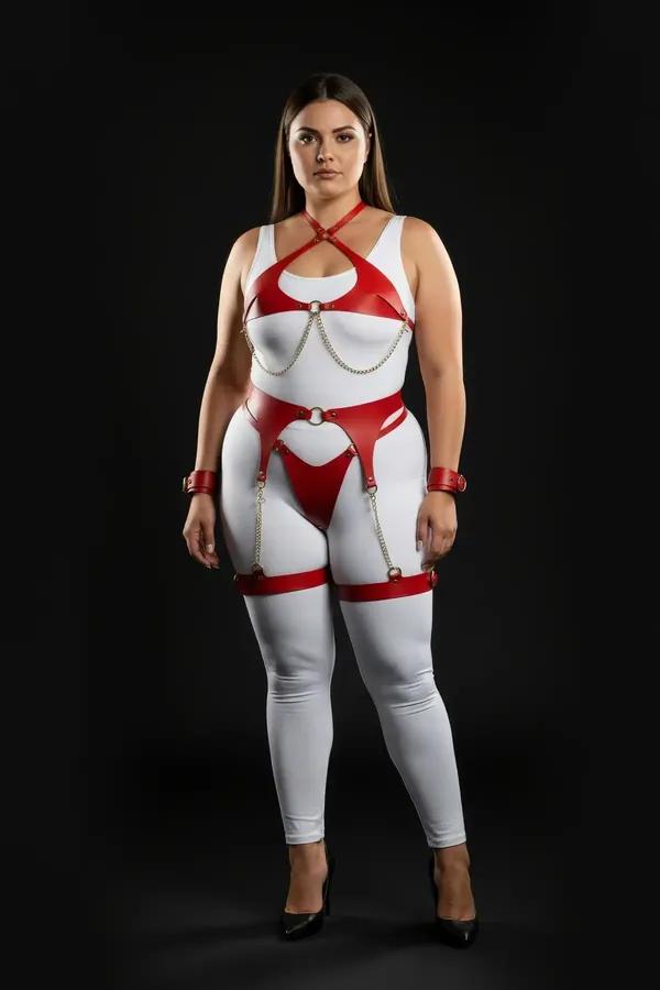 Red faux leather harness set with gold chains on plus-size model — chest harness, waist belt, garter straps, thigh bands and 