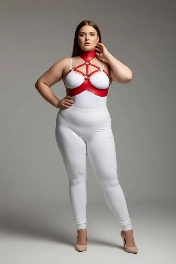 Red faux leather collar and chest harness set with gold-tone cage straps on plus-size model, white background