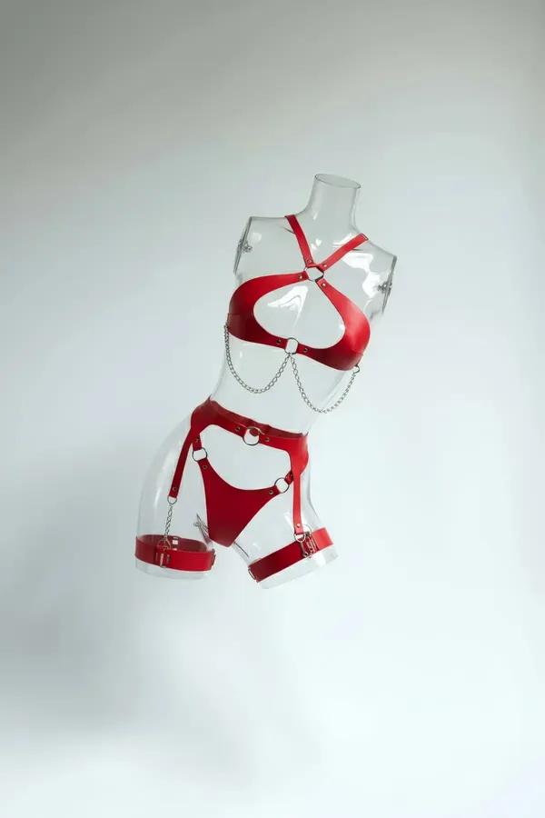 Red faux leather body harness set featuring silver-tone chest chain drapes, garter belt, and buckled thigh straps