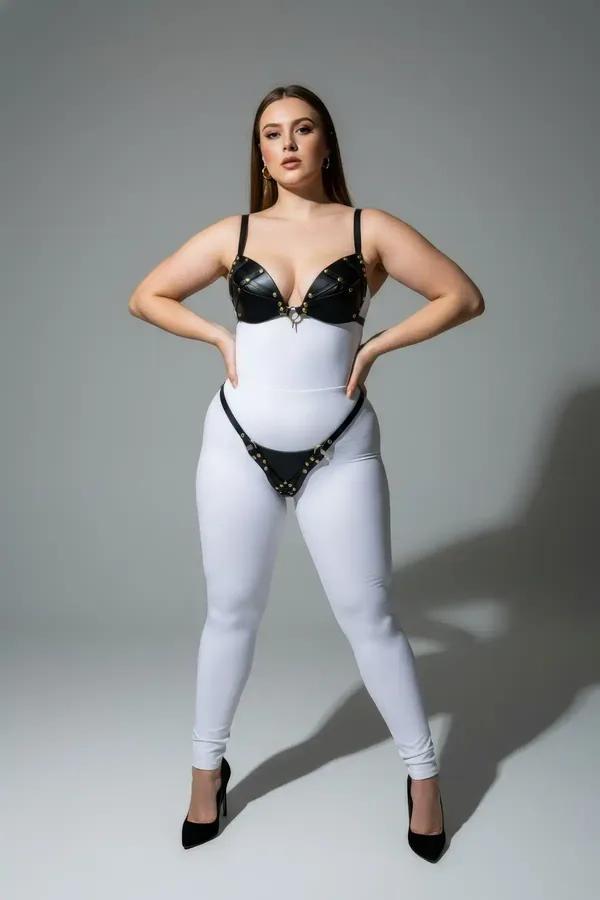 black faux leather studded bra and thong harness set with gold-tone stud trim and center O-ring detail