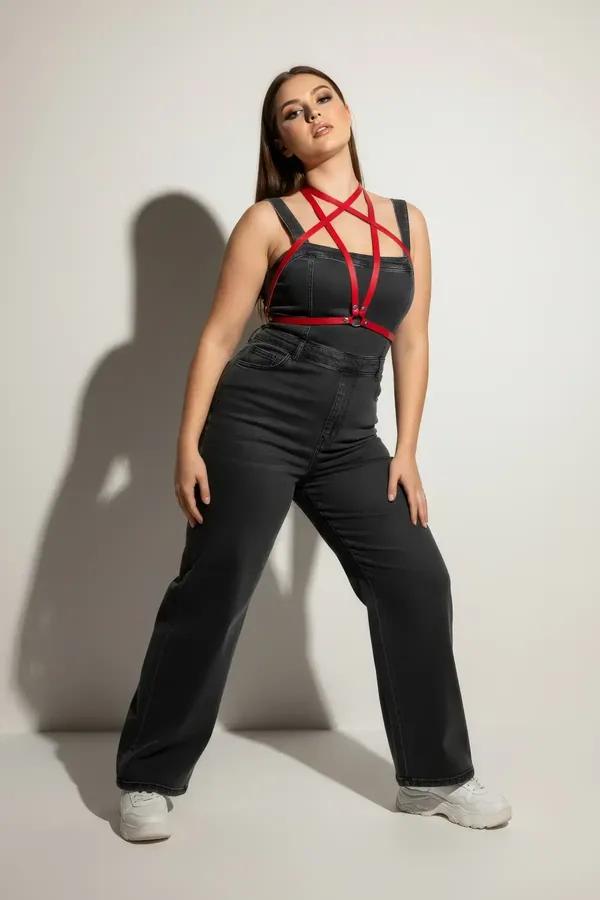 red faux leather overbust harness with waist belt and silver O-ring worn over a black dress