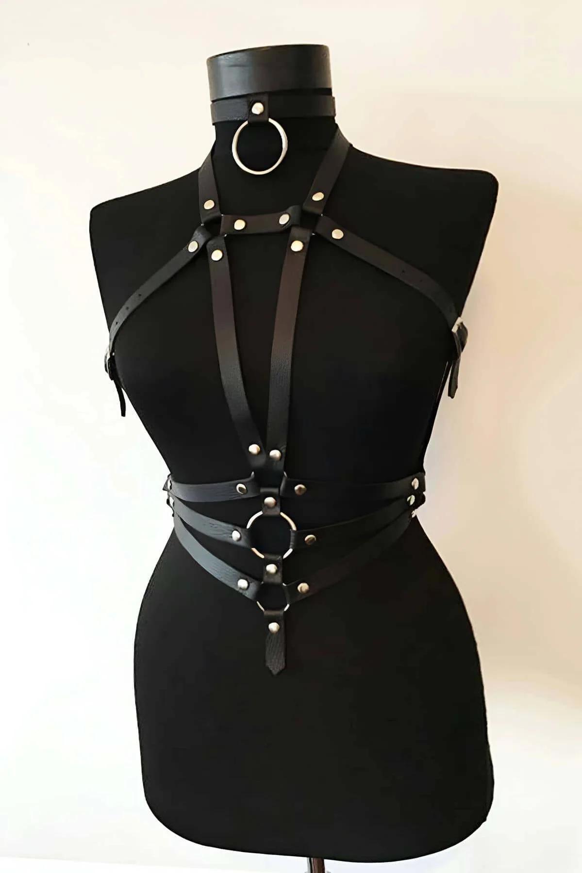 Side profile view showing the underbust buckle adjustment of the black leather harness