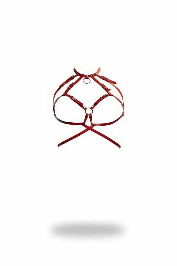 Red faux leather caged chest harness with dual silver O-rings and rivet-studded straps on white background