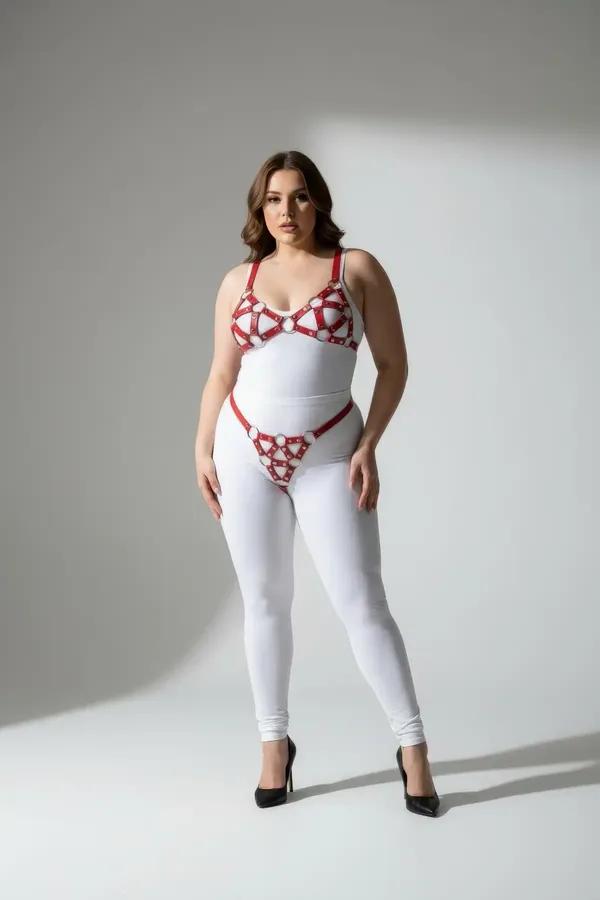 red faux leather cage bra and panty harness set with chrome O-rings and geometric strap pattern on plus-size model