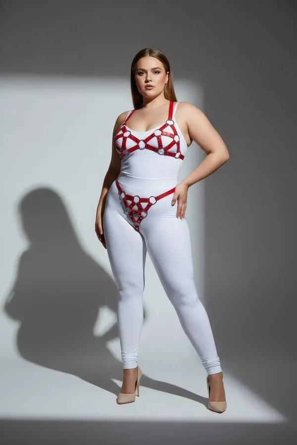 red faux leather cage bra and panty harness set with chrome O-rings and geometric strap pattern on plus-size model