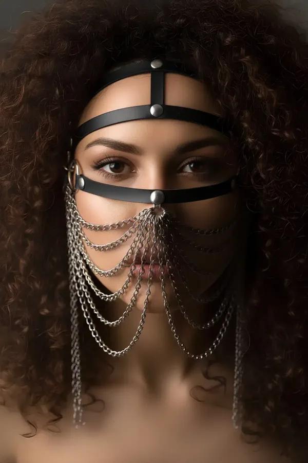 black faux leather face harness with seven draping silver chains and O-ring detail worn as a chain veil mask