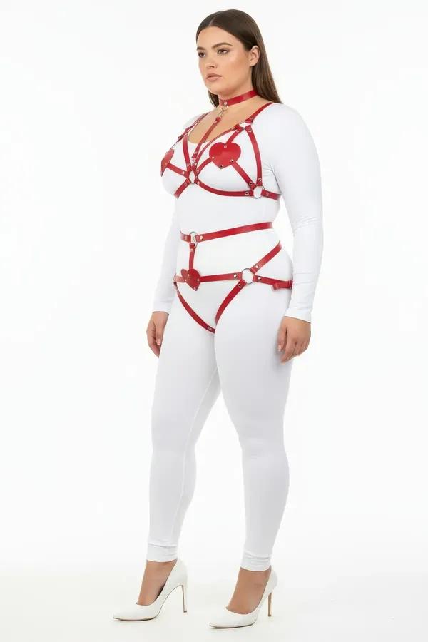 red faux leather body harness set with heart detail patches and silver O-rings worn over white bodysuit plus size model