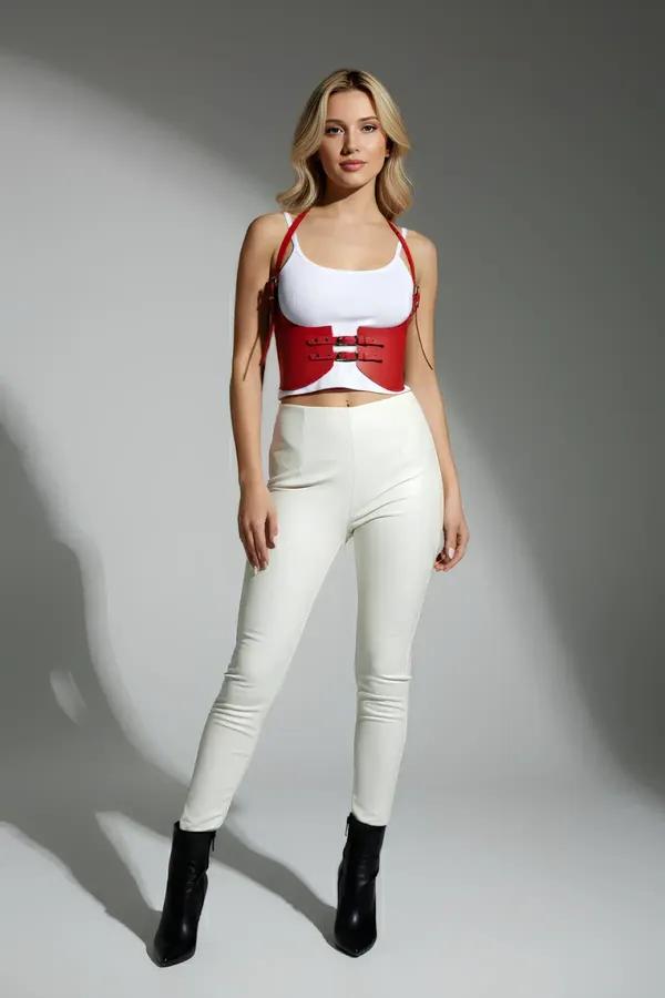red faux leather underbust harness with three silver buckles and adjustable halter straps worn over white top