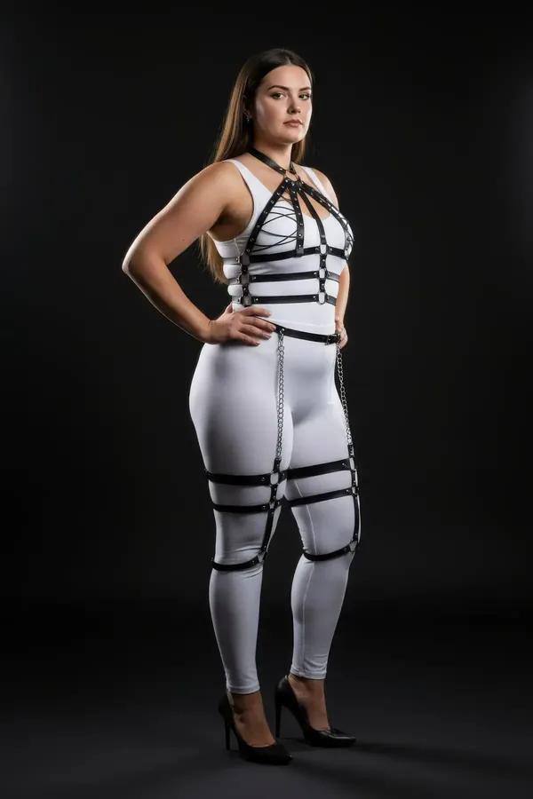Black faux leather plus size full body harness with silver drop thigh chains, O-ring sternum detail, and studded horizontal c