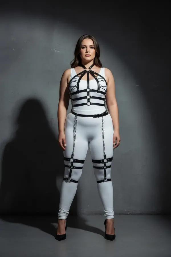 Black faux leather plus size full body harness with silver drop thigh chains, O-ring sternum detail, and studded horizontal c