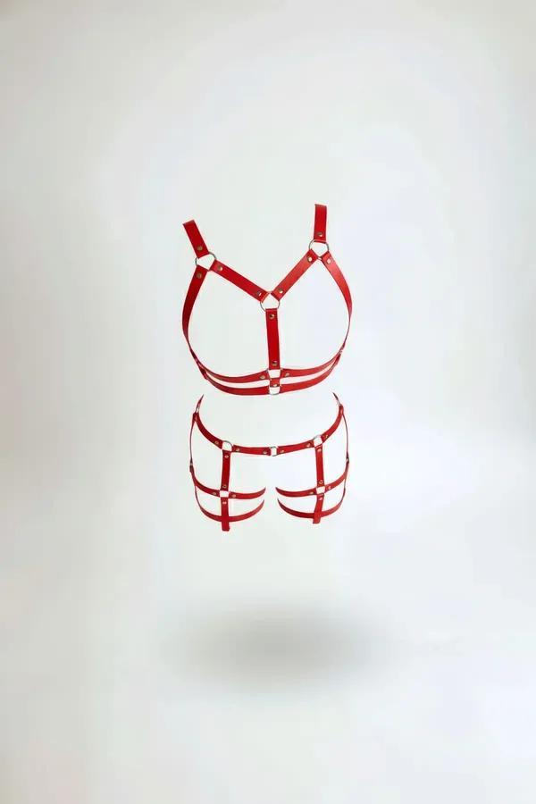 red faux leather body harness set with silver O-rings chest bra and garter cage straps on white background