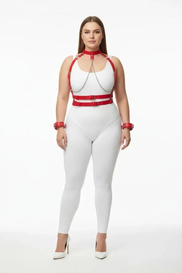 red faux leather chest harness and collar set with silver drape chains and wrist cuffs worn over white bodysuit