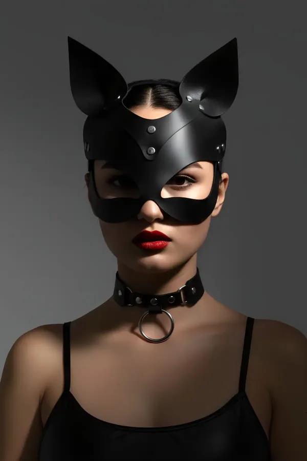 black faux leather cat mask with stand-up ears and silver studs worn with matching O-ring choker