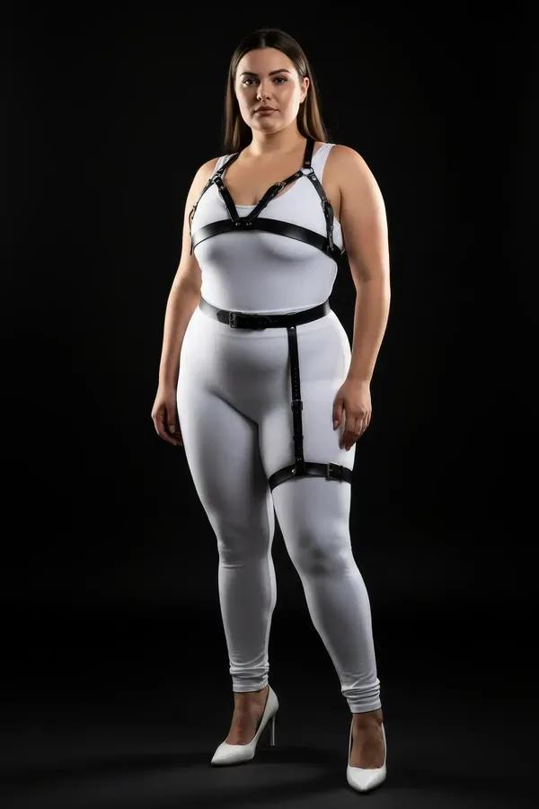 Black faux leather harness bra and thigh garter set with silver buckles worn over white outfit