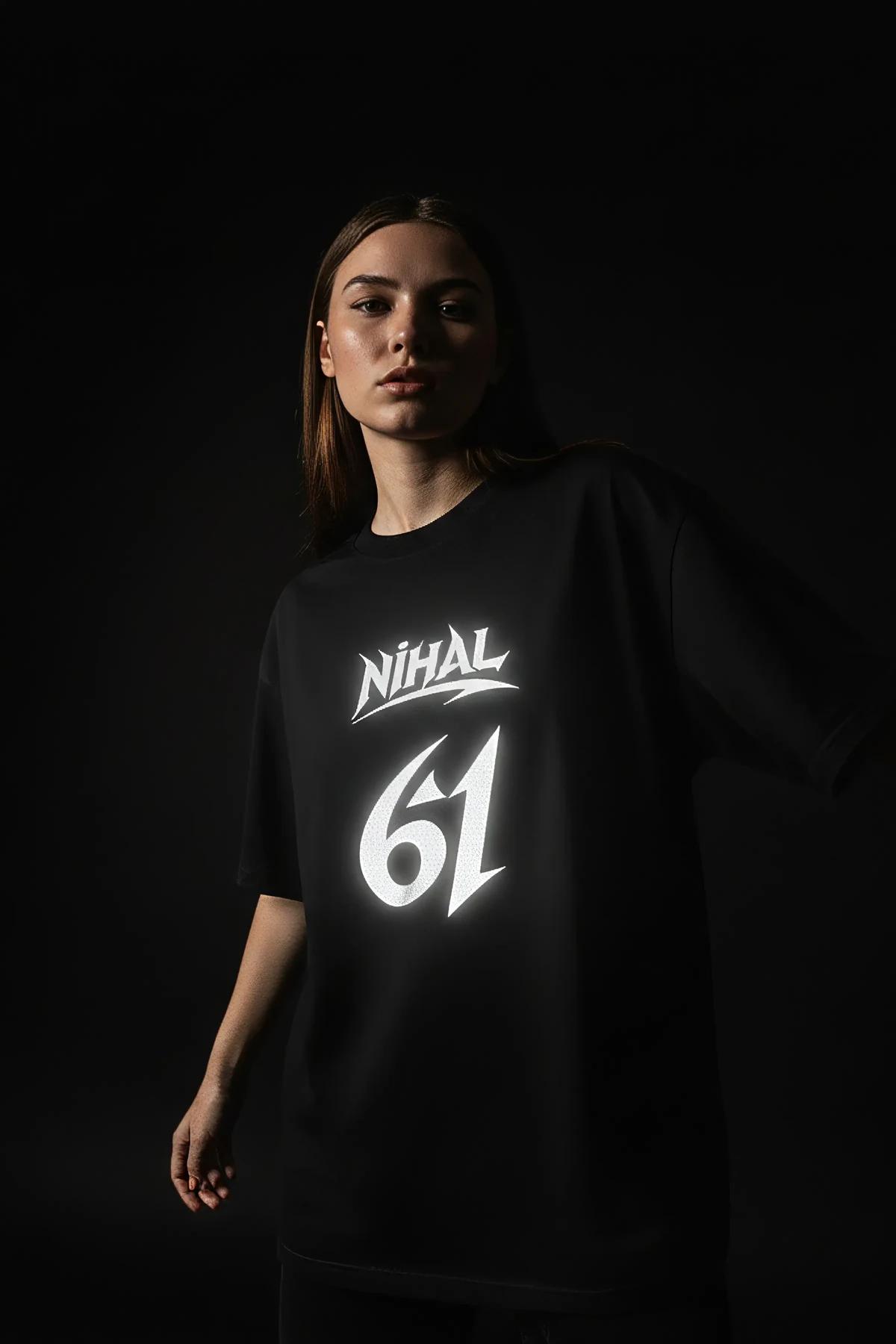 black oversized cotton tee with large reflective graphic print on chest, boxy dropped-shoulder fit