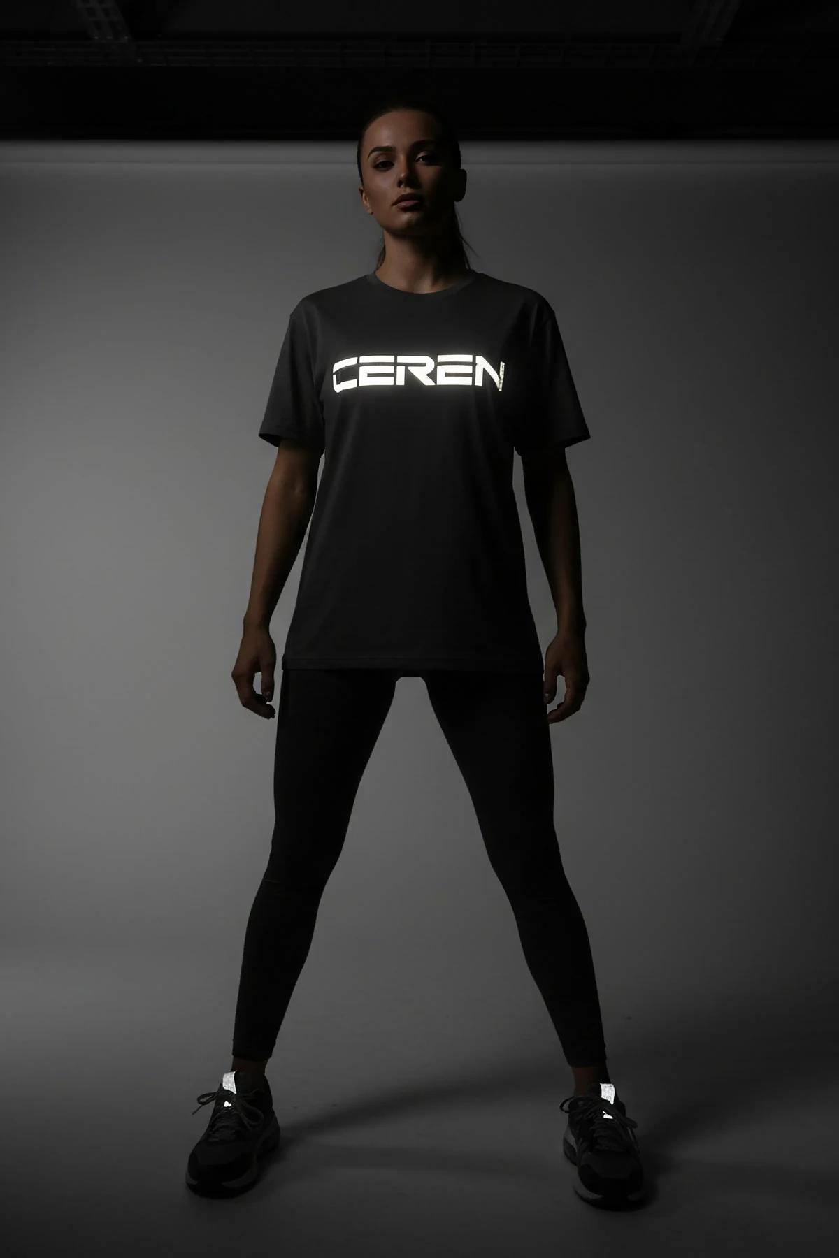 black reflective graphic t-shirt with glowing Yeditepe Dance Club chest print photographed in low light