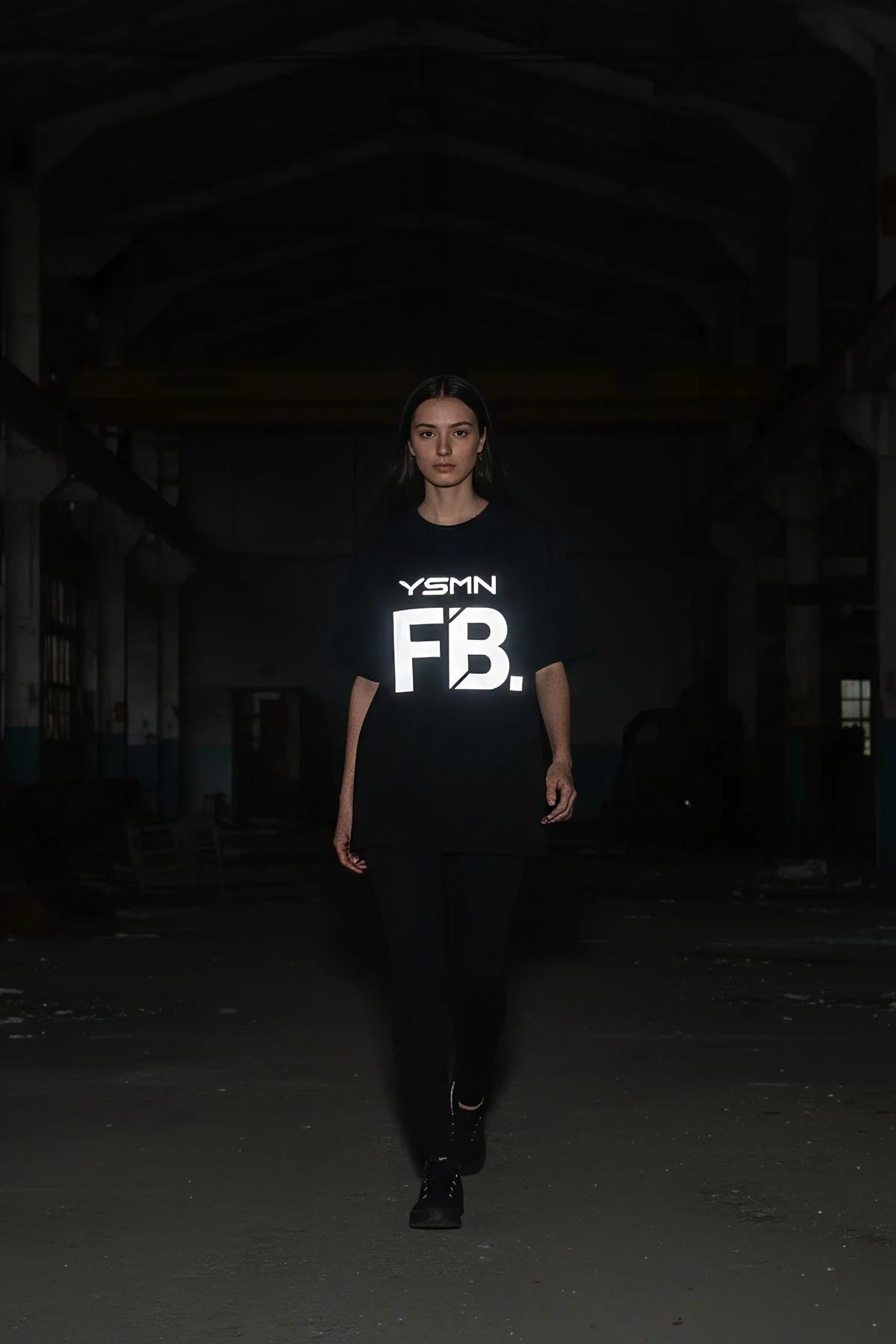 Black t-shirt with reflective YSMN FB logo graphic on front