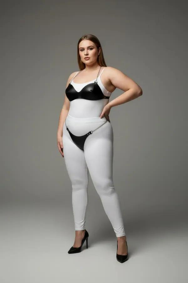 black faux leather bra and garter harness set with silver chain accents worn over white leggings, two-piece intimate fashion