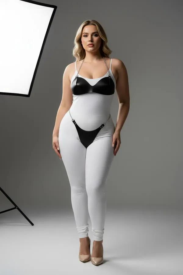black faux leather bra and garter harness set with silver chain accents worn over white leggings, two-piece intimate fashion