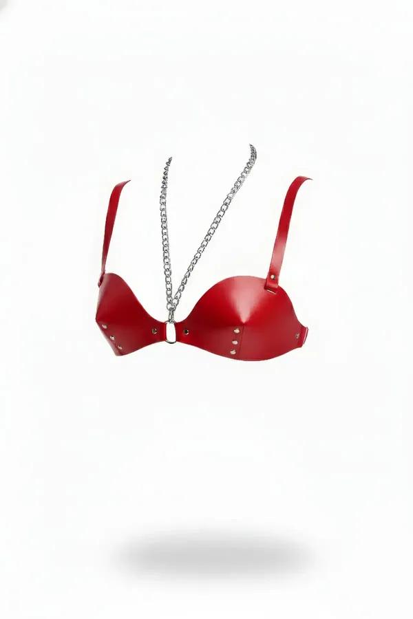 Faux leather chest harness in red featuring molded cups with silver underbust studs and a draped halter-style chain.