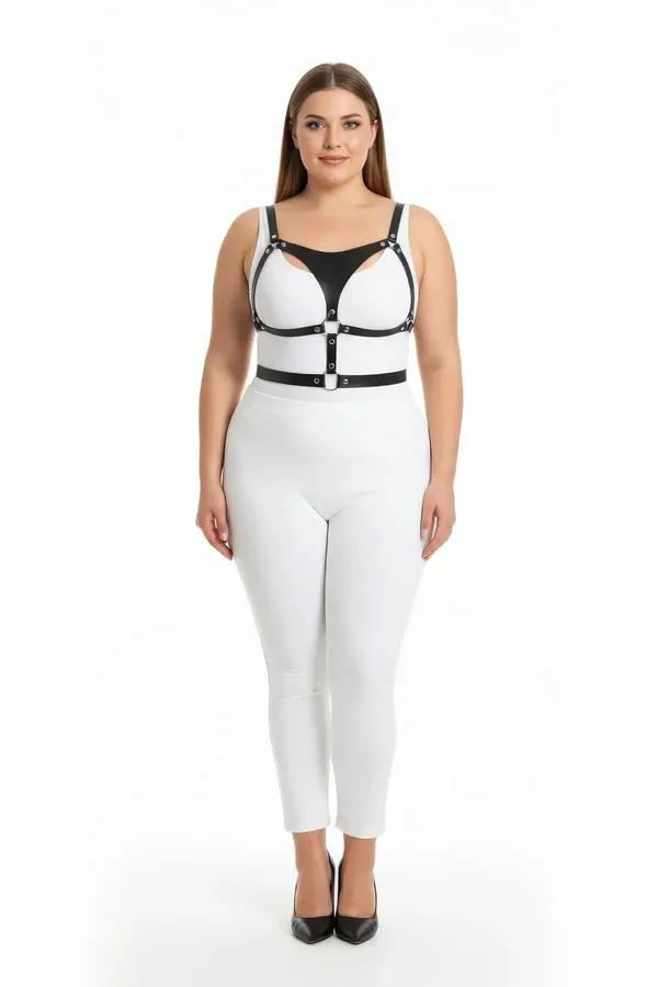 black faux leather strappy body harness with cage chest cutouts and silver O-ring hardware worn over white outfit