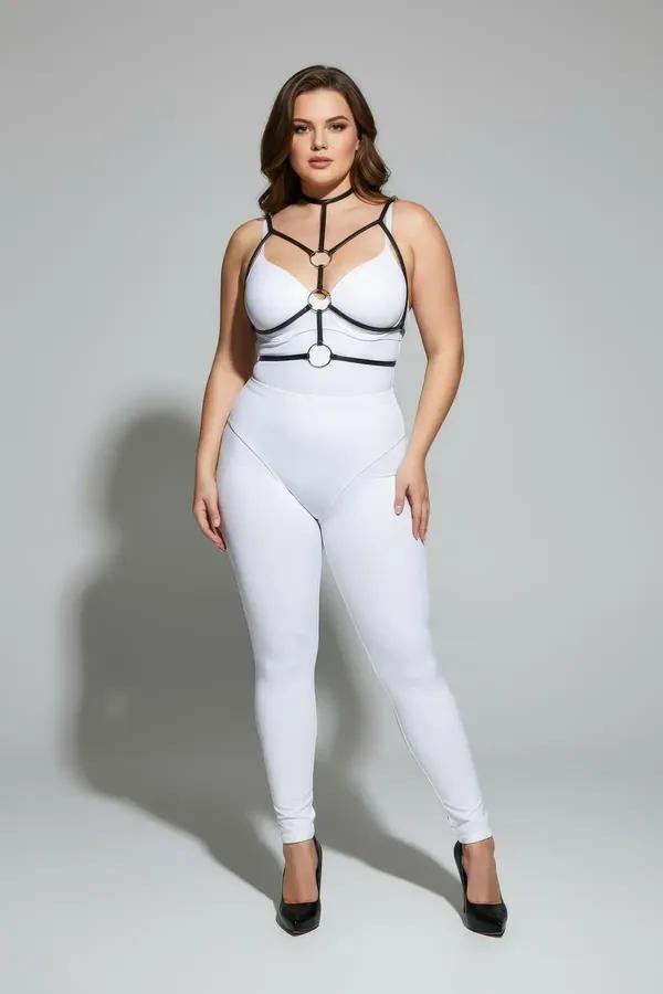 Black faux leather strappy chest harness with double gold O-rings and choker neck strap worn over white outfit