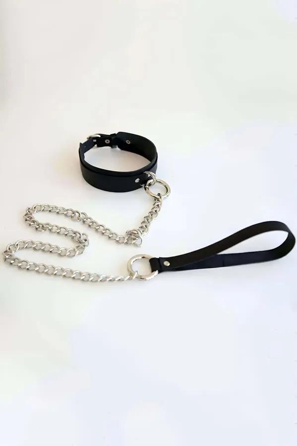 black faux leather choker with silver curb chain and loop handle set laid flat on white background