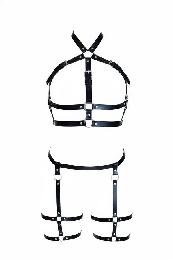 black faux leather caged body harness and thigh garter set with silver O-rings and stud rivets laid flat on white background