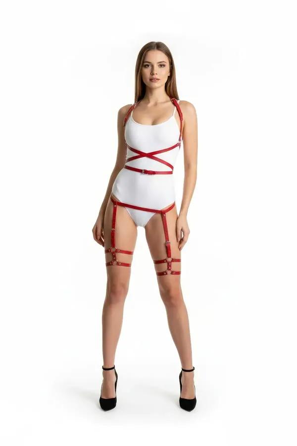 Red faux leather cross-strap body harness with matching thigh garter bands and silver O-ring hardware