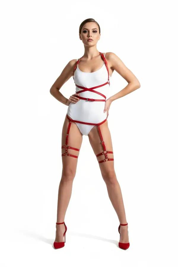 Red faux leather cross-strap body harness with matching thigh garter bands and silver O-ring hardware