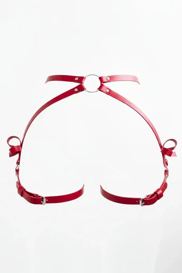 Red faux leather body harness with central silver O-ring and bow accents, adjustable buckle straps