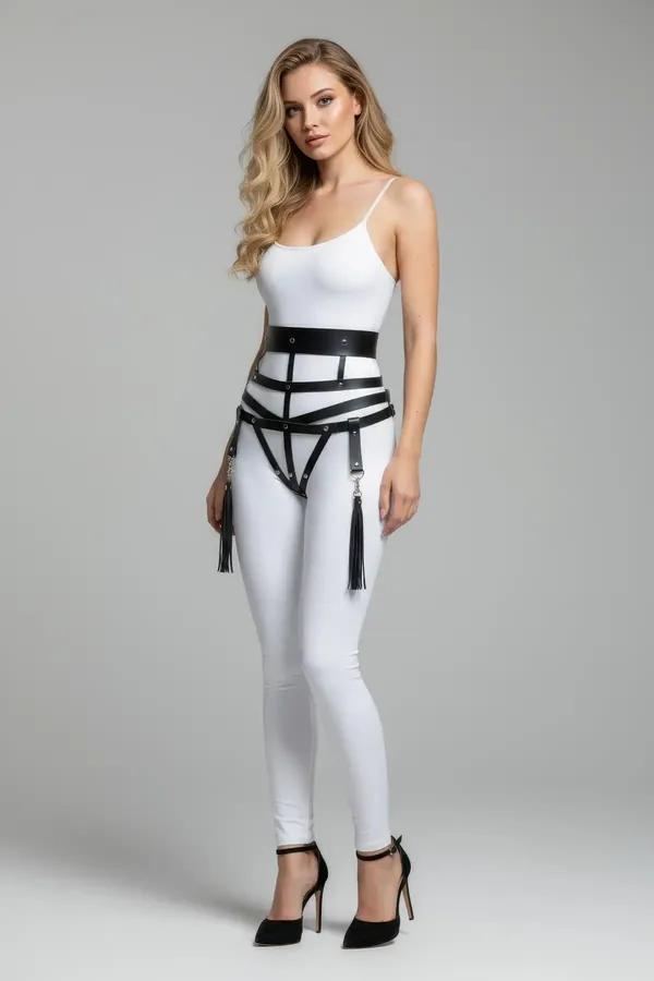 black faux leather caged waist harness with silver O-rings and tassel drops worn over white bodysuit