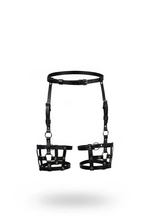 Black faux leather garter harness with structured cage leg bands, silver O-rings and waist belt, front view on white backgrou
