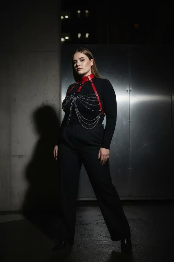 Red faux leather chain body harness with wide choker collar and cascading silver chain drape over chest