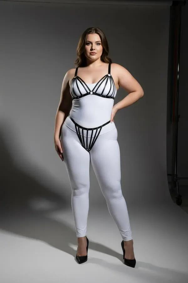black faux leather strappy cage harness bra and thong set with silver stud hardware on plus-size model