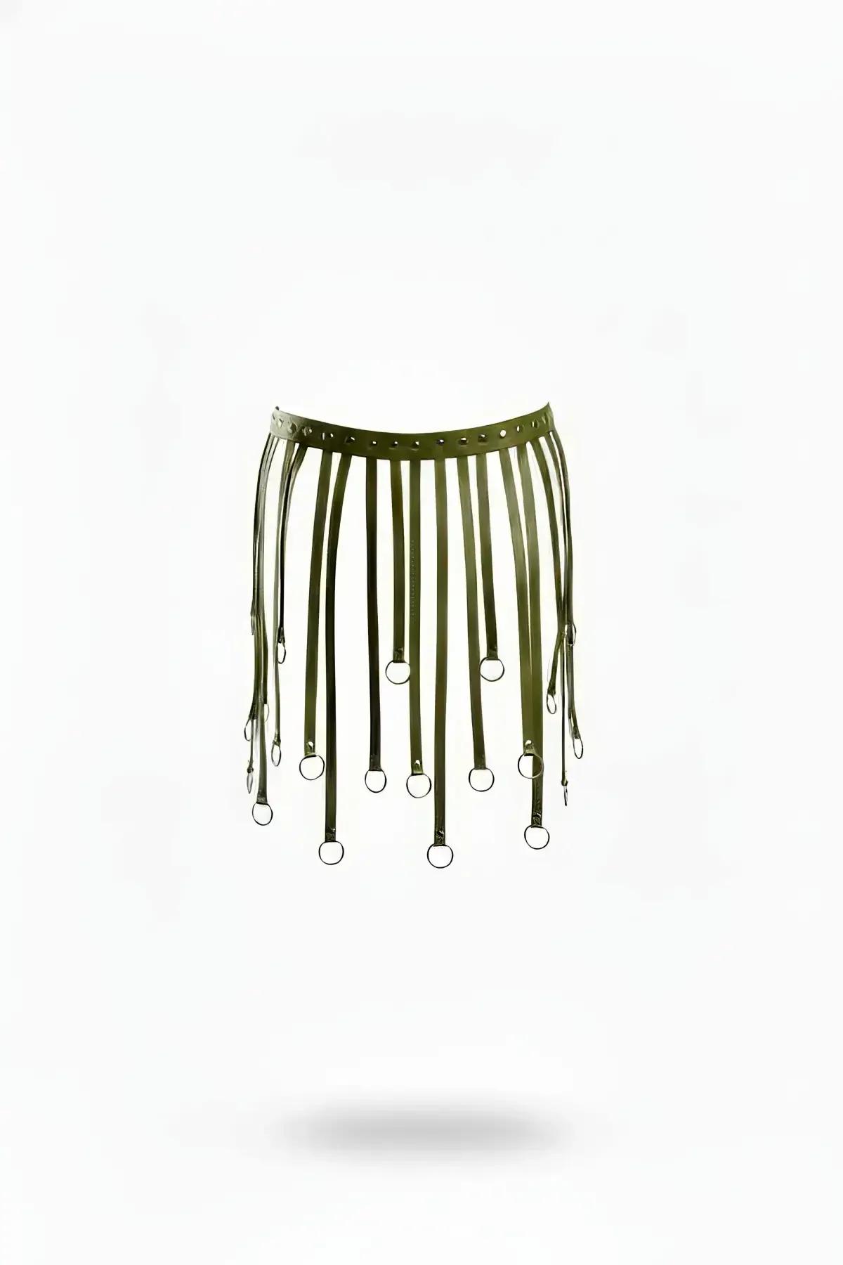 Olive green vegan leather harness skirt overlay with staggered vertical straps tipped with silver O-rings on flat lay view.