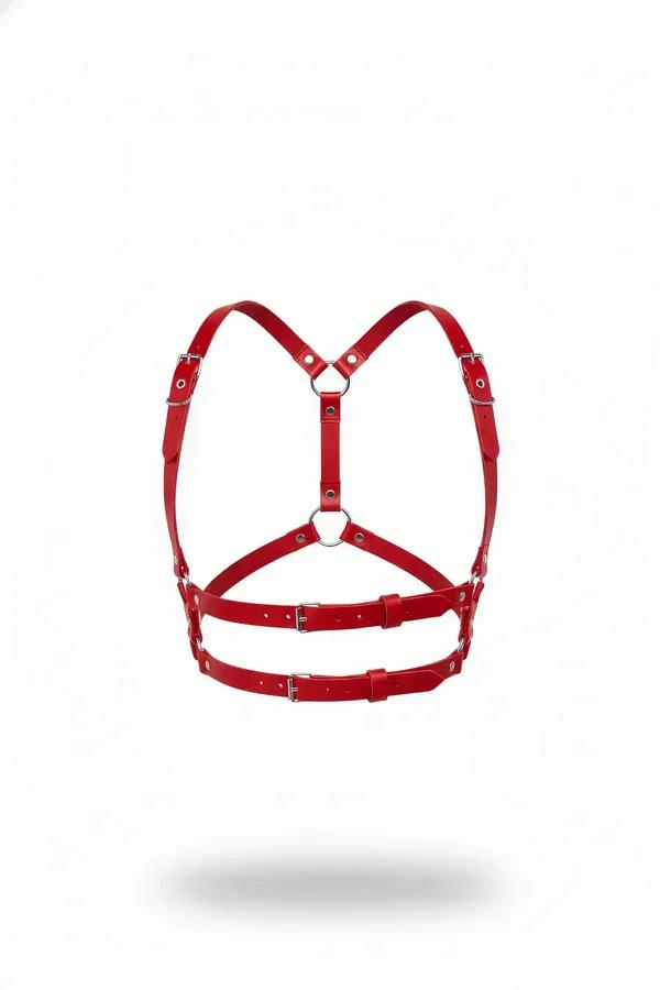 Red faux leather chest harness with silver O-rings and six buckles, structured cage silhouette on white background