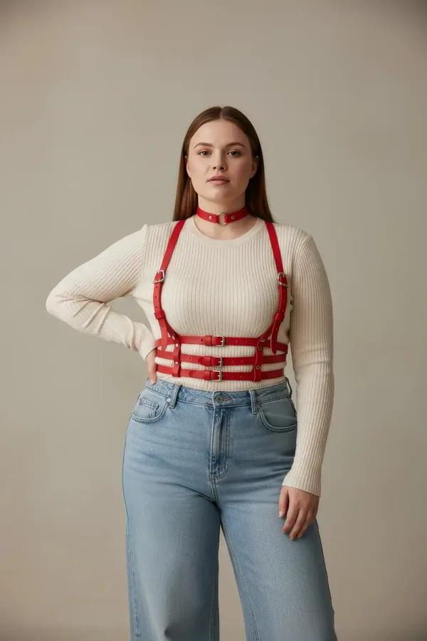red faux leather caged underbust harness with three buckled horizontal bands and matching O-ring choker worn over white tank