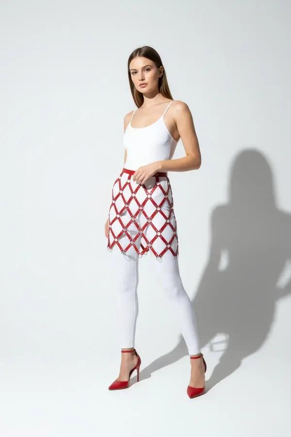 red and white argyle faux leather waist harness skirt with silver O-ring lattice intersections mid-thigh length