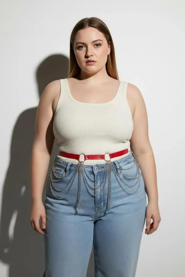 red faux leather waist belt with layered silver draping chains worn at natural waist over beige trousers