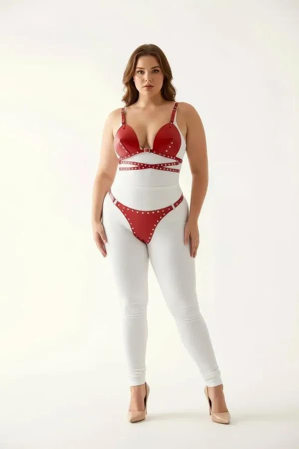 Red faux leather bra harness set with silver stud crossover straps and matching hip band on plus-size model