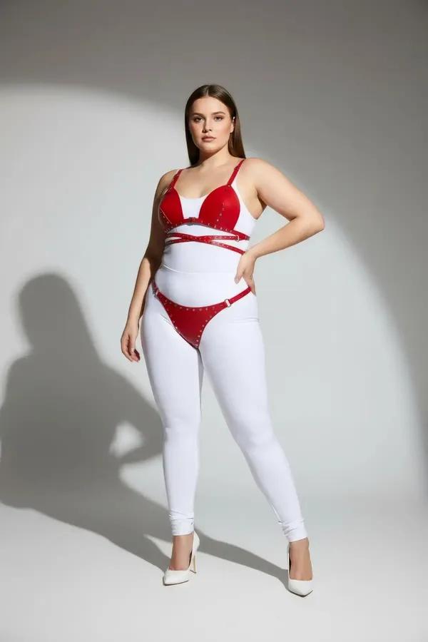 Red faux leather bra harness set with silver stud crossover straps and matching hip band on plus-size model