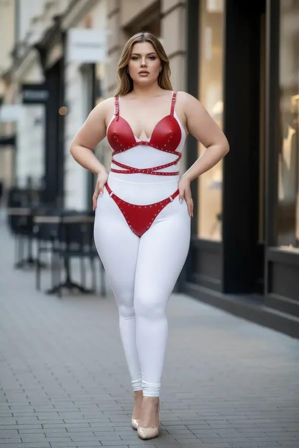 Red faux leather bra harness set with silver stud crossover straps and matching hip band on plus-size model