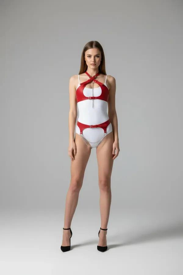 red faux leather chest harness and garter belt set with cross-front straps and silver chain details, full front view