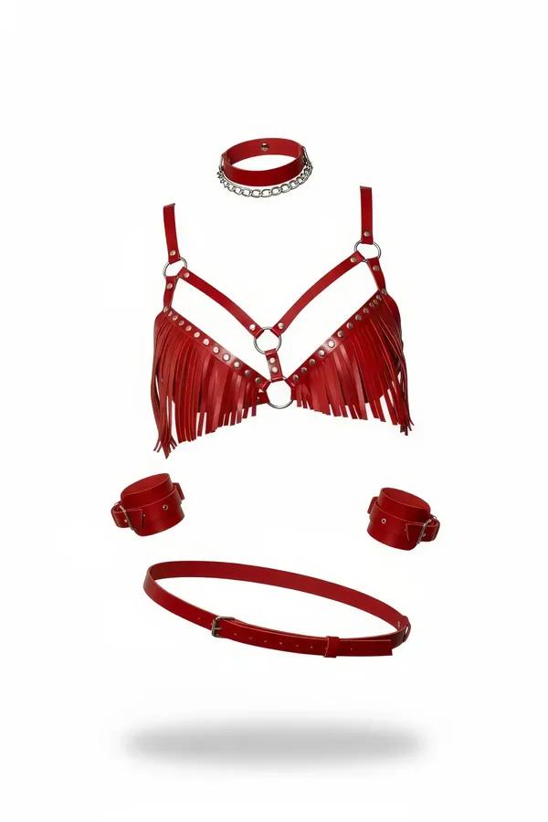 Red faux leather fringed harness bra set with silver O-rings, chain choker, wrist cuffs, and waist belt laid flat on white ba