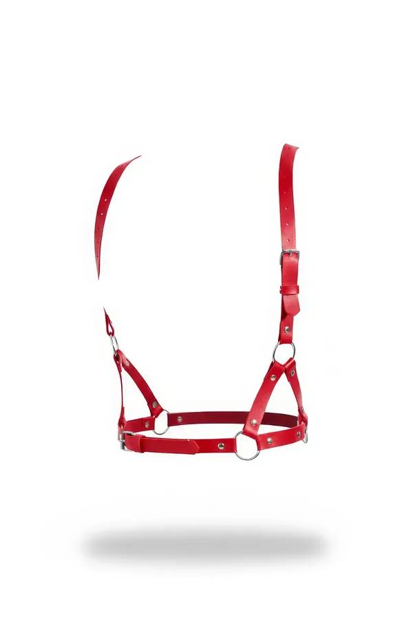 Red faux leather o-ring chest harness bra with silver buckles and cross-strap panel on white background