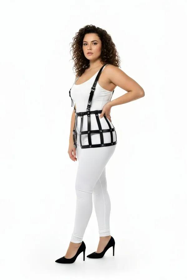 black faux leather caged waist harness with over-the-shoulder suspender straps and matte black O-ring hardware, worn over whi