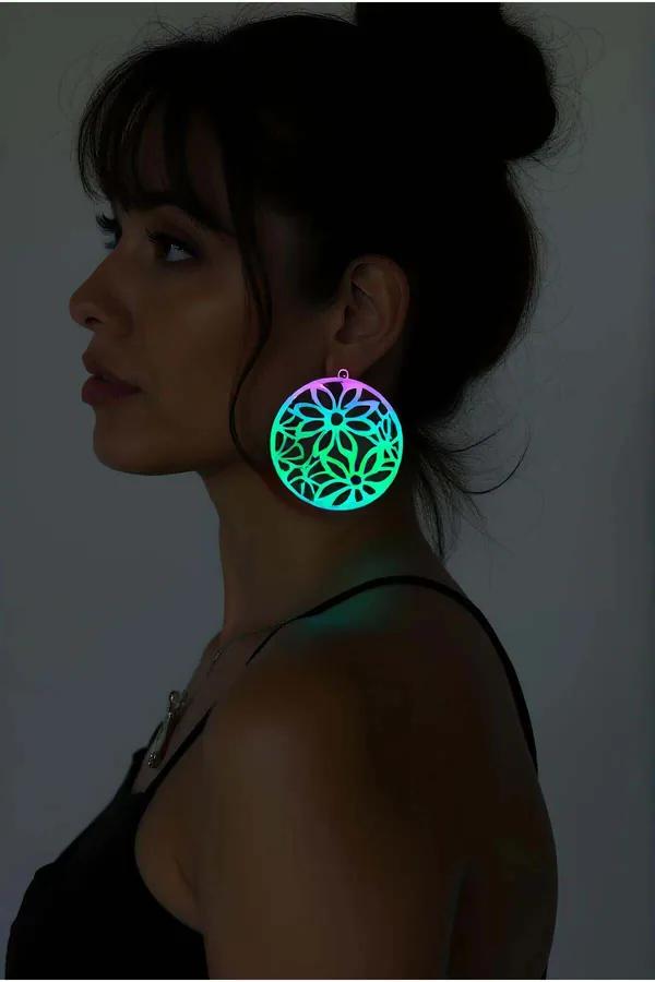 Rainbow iridescent floral drop earrings large circular laser-cut disc pink to teal holographic finish worn on ear