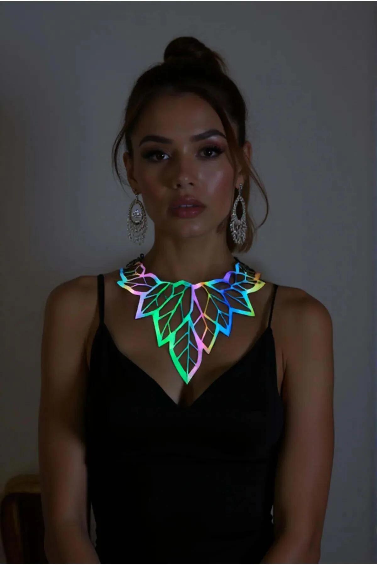 Iridescent holographic leaf choker necklace with rainbow-reflective acrylic panel worn at collarbone on black top